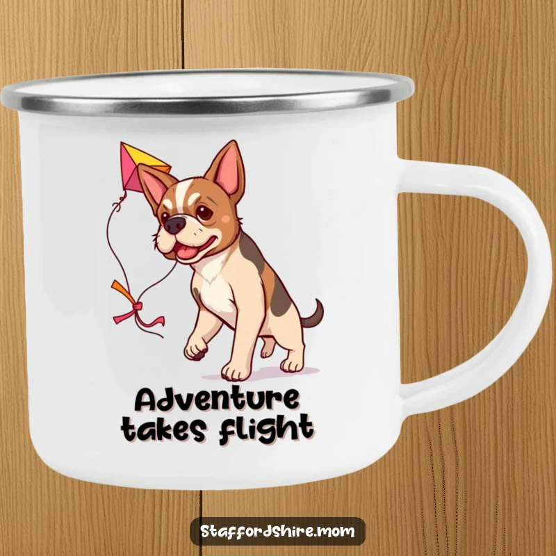 Funny determined Staffordshire dog camping mug, carrying a colorful kite, humorous and durable outdoor cup.