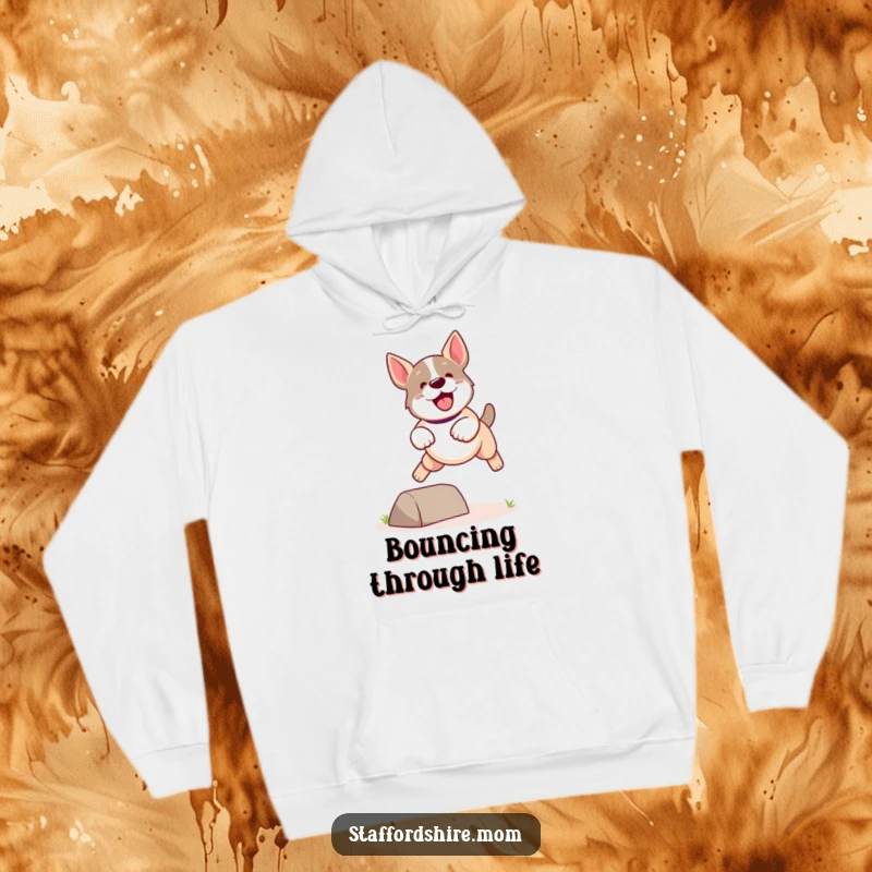 Funny Kawaii Staffordshire Dog Hoodie showcasing a cute, energetic dog leaping playfully over a small obstacle, warm and fun.