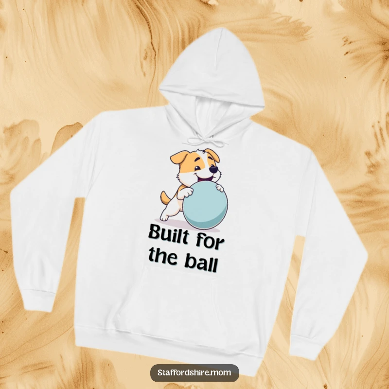 Funny Dog Hoodie: A sturdy dog with a strong build joyfully retrieving a large toy, embodying playful strength.