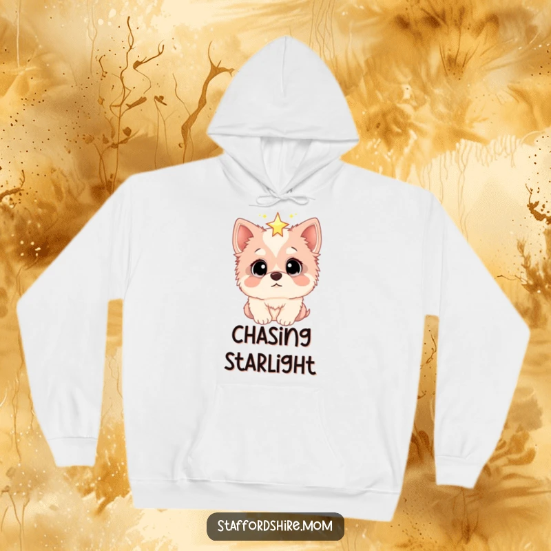 Funny hoodie depicting a Staffordshire dog with incredibly wide eyes, gazing up in admiration at a shimmering star, evoking a sense of magic.
