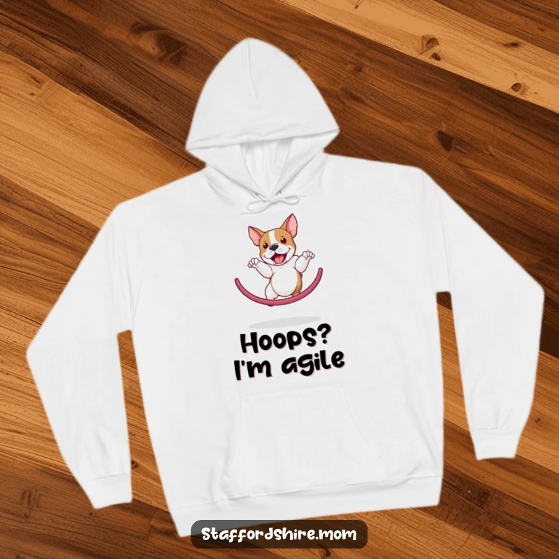 Funny Staffordshire Bull Terrier hoodie depicting a dog performing a spectacular hoop jump, showcasing agility and a playful spirit.
