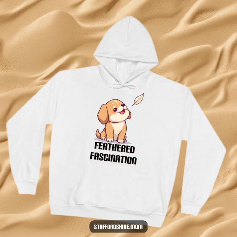 Funny hoodie depicting a solid build dog looking up with gentle amusement at a light, floating feather.