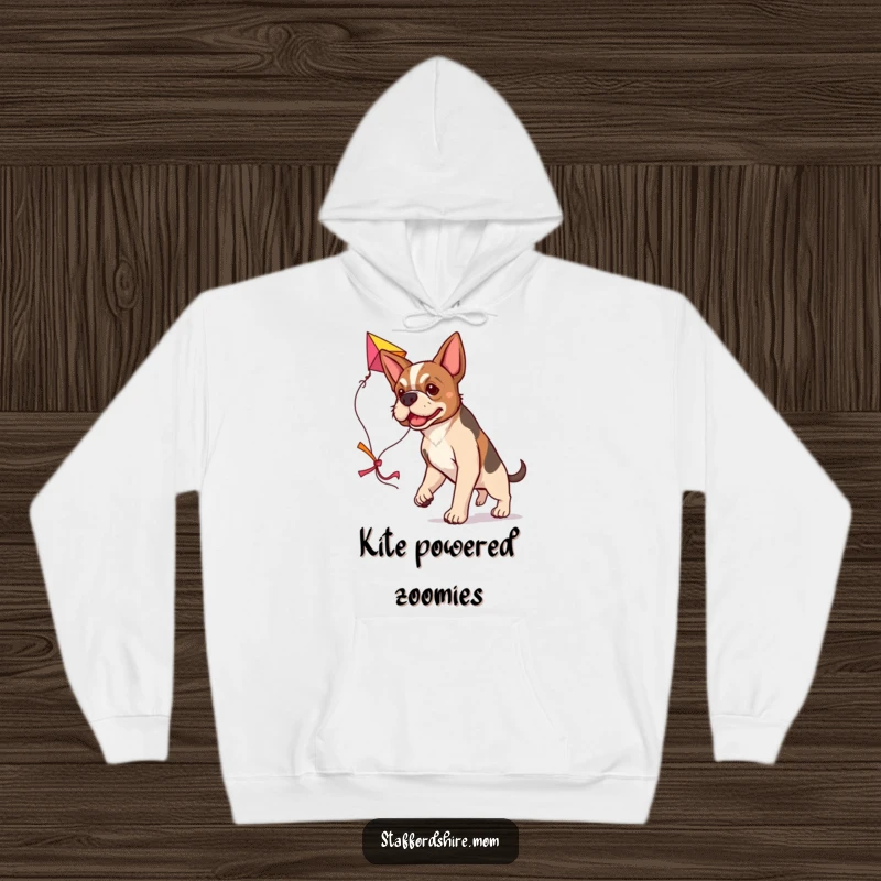 Funny determined Staffordshire dog hoodie, carrying a large colorful kite, cozy and motivational pet wear.