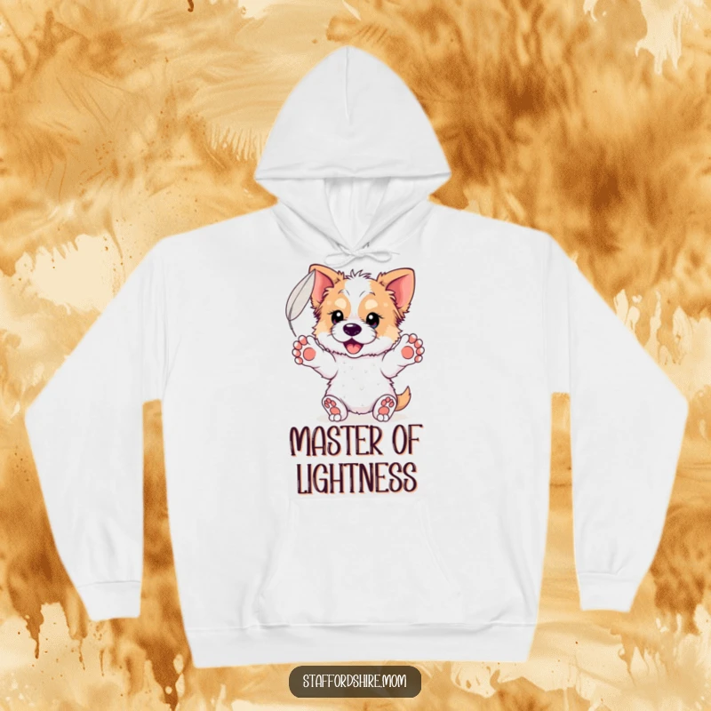 Funny Staffordshire Feather Hoodie: A comfortable hoodie featuring a dog with paws outstretched, gently catching a floating feather.