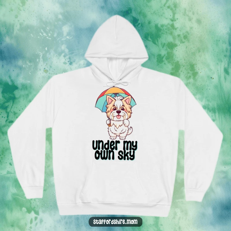 Funny hoodie showing a happy Staffordshire dog waving hello while holding a big, colorful rainbow umbrella for protection and cheer.
