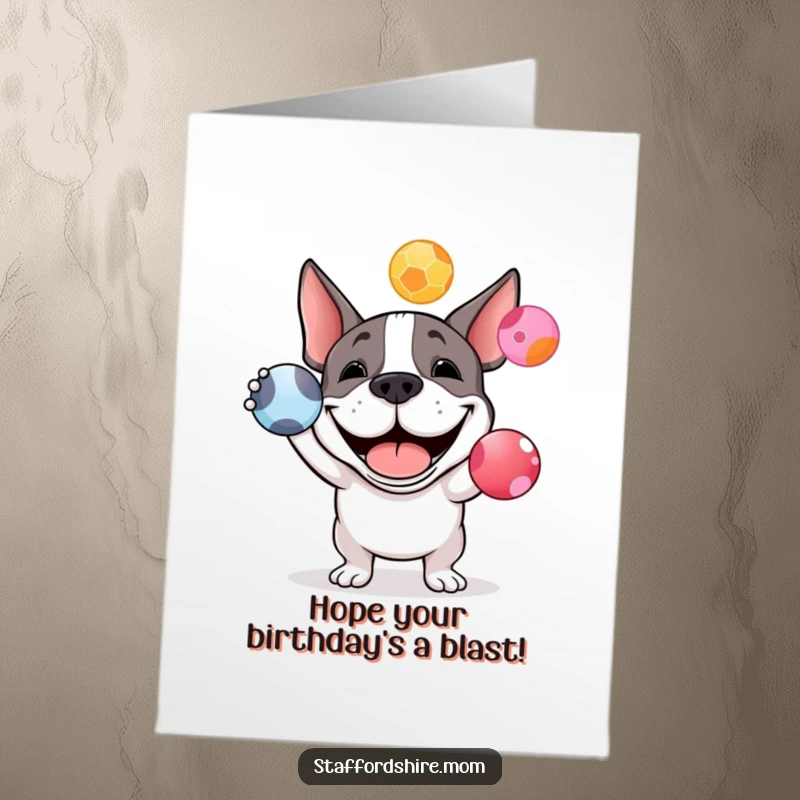 Funny Free Printable Birthday Card featuring a happy Staffordshire bull terrier grinning while attempting to juggle three colorful balls.