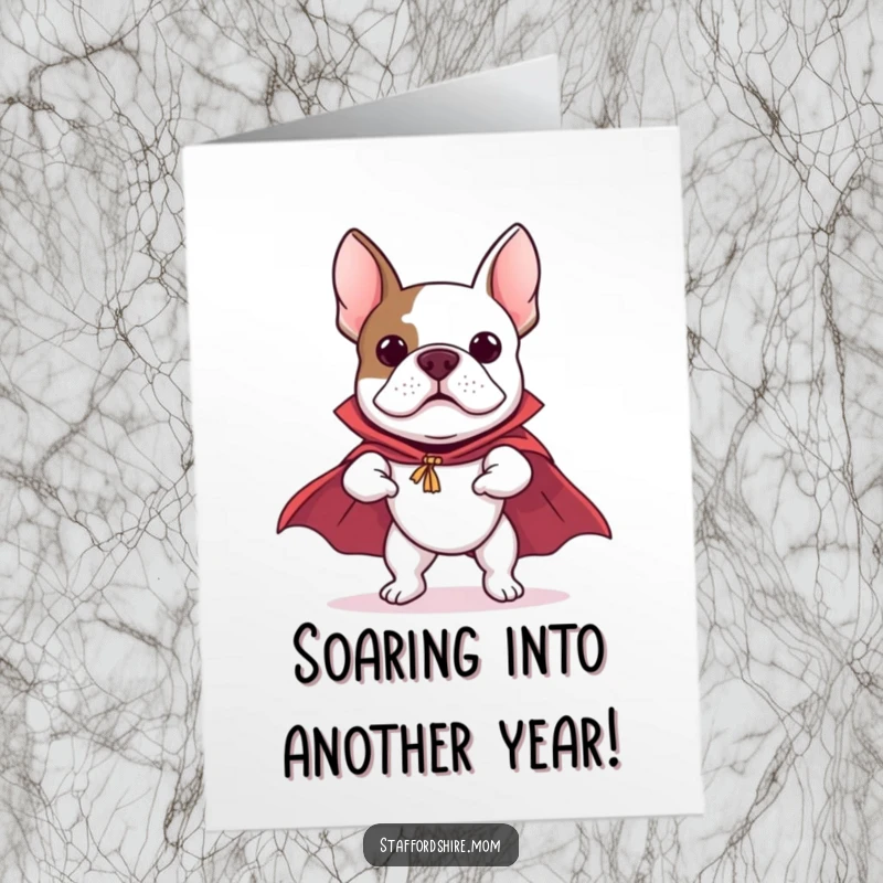 Funny free printable birthday card: A Staffordshire Bull Terrier in a cape, leaping and pretending to fly with determination.