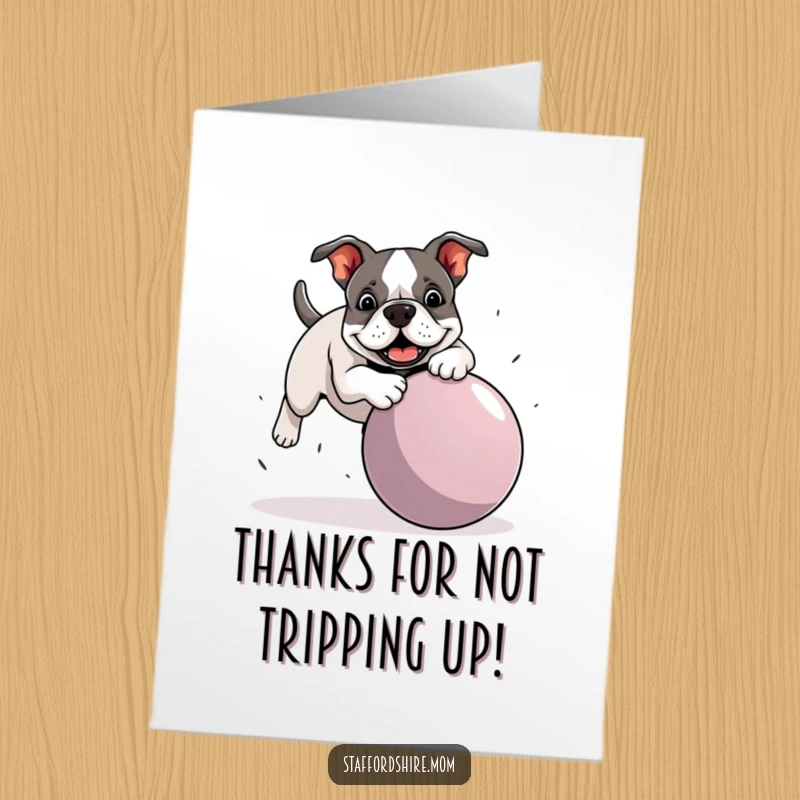 Funny free printable thank you card: A Staffordshire Bull Terrier comically tripping over a giant ball, looking surprised.