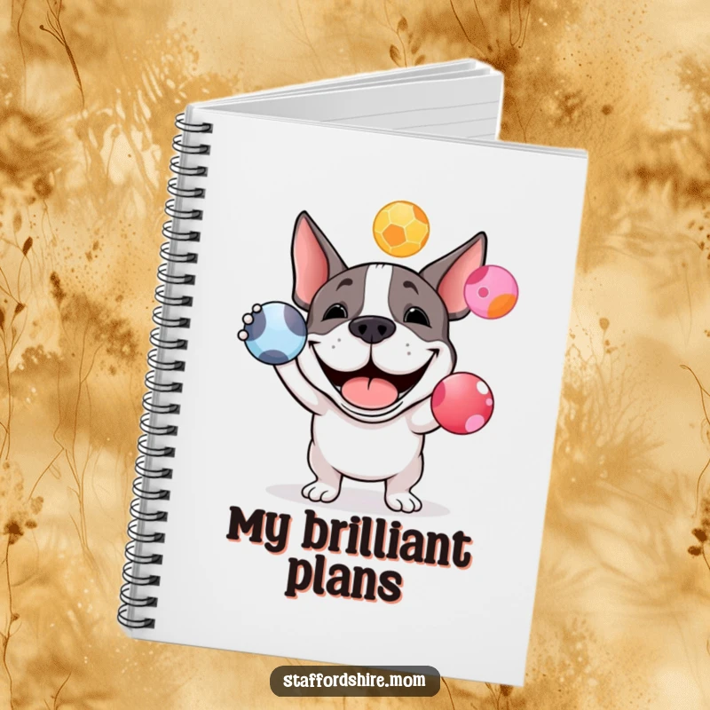 Funny Staffy bull terrier notebook with a happy dog grinning and juggling colorful balls, providing a space for notes and creativity.