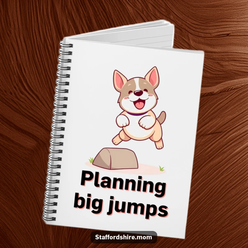 Funny Kawaii Staffordshire Dog Notebook featuring a cute, energetic dog leaping playfully over a small obstacle, for active notes.