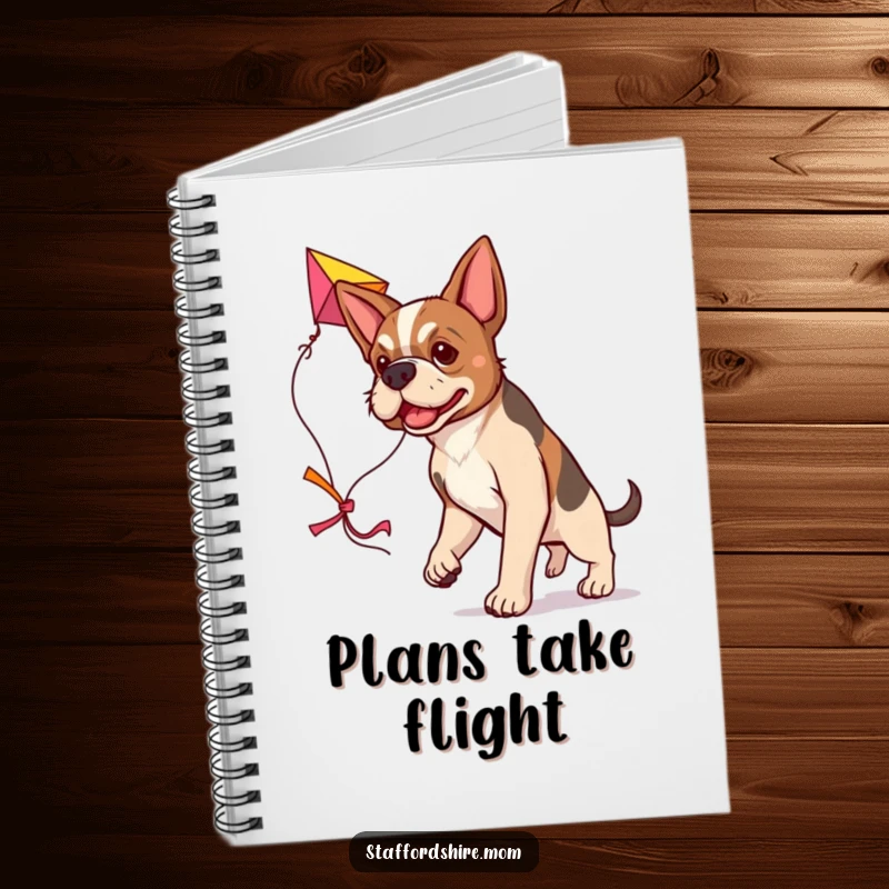 Funny determined Staffordshire dog notebook, carrying a large colorful kite, humorous stationery for planners.