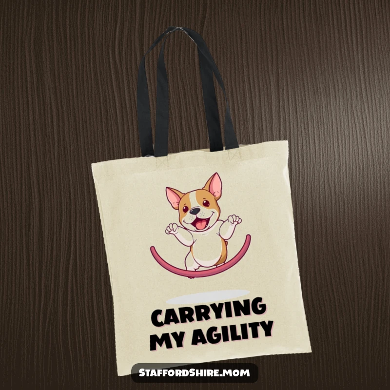 Funny Staffordshire Bull Terrier tote bag illustrating a dog's impressive and agile jump through a hoop, perfect for dog enthusiasts.