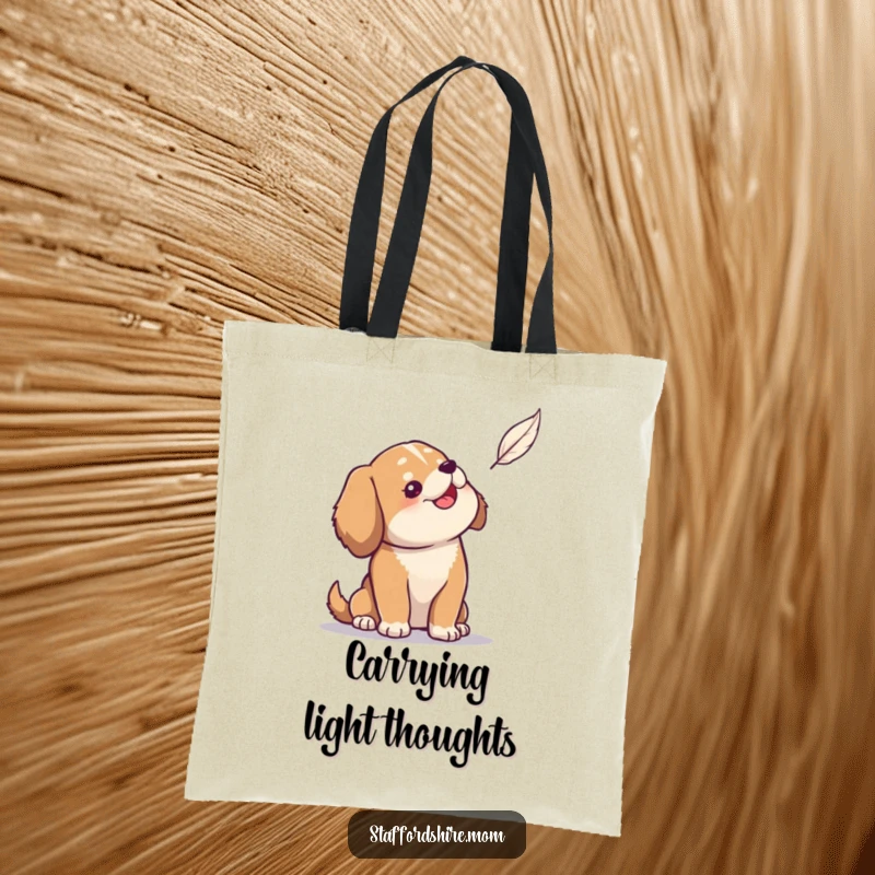 Funny tote bag showing a solidly built dog looking up with amusement at a single floating feather.