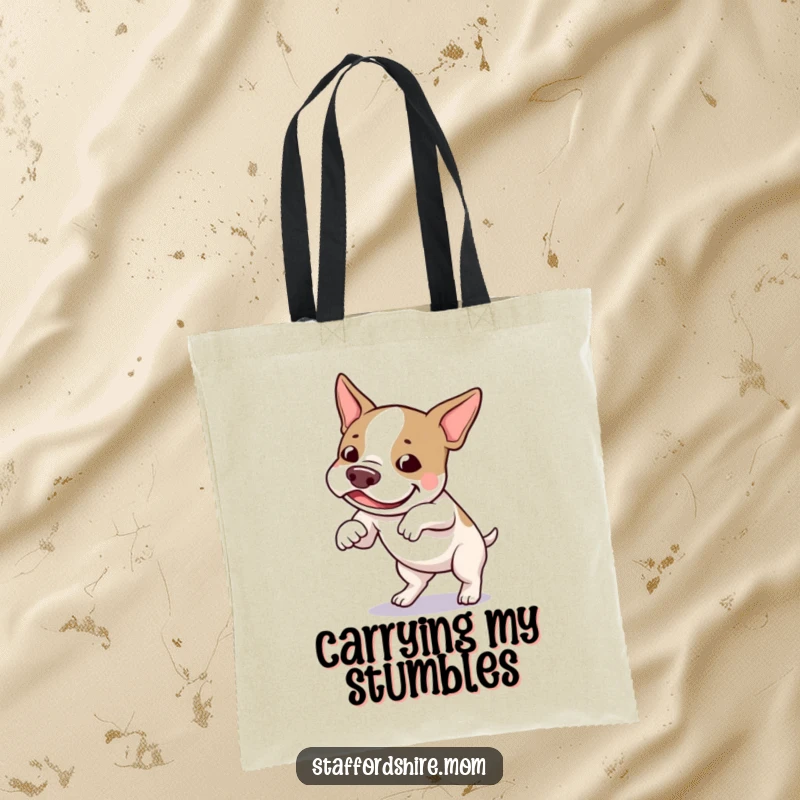 Funny Staffordshire bull terrier tote bag depicting a dog playfully tripping over its feet with a look of pure amusement.
